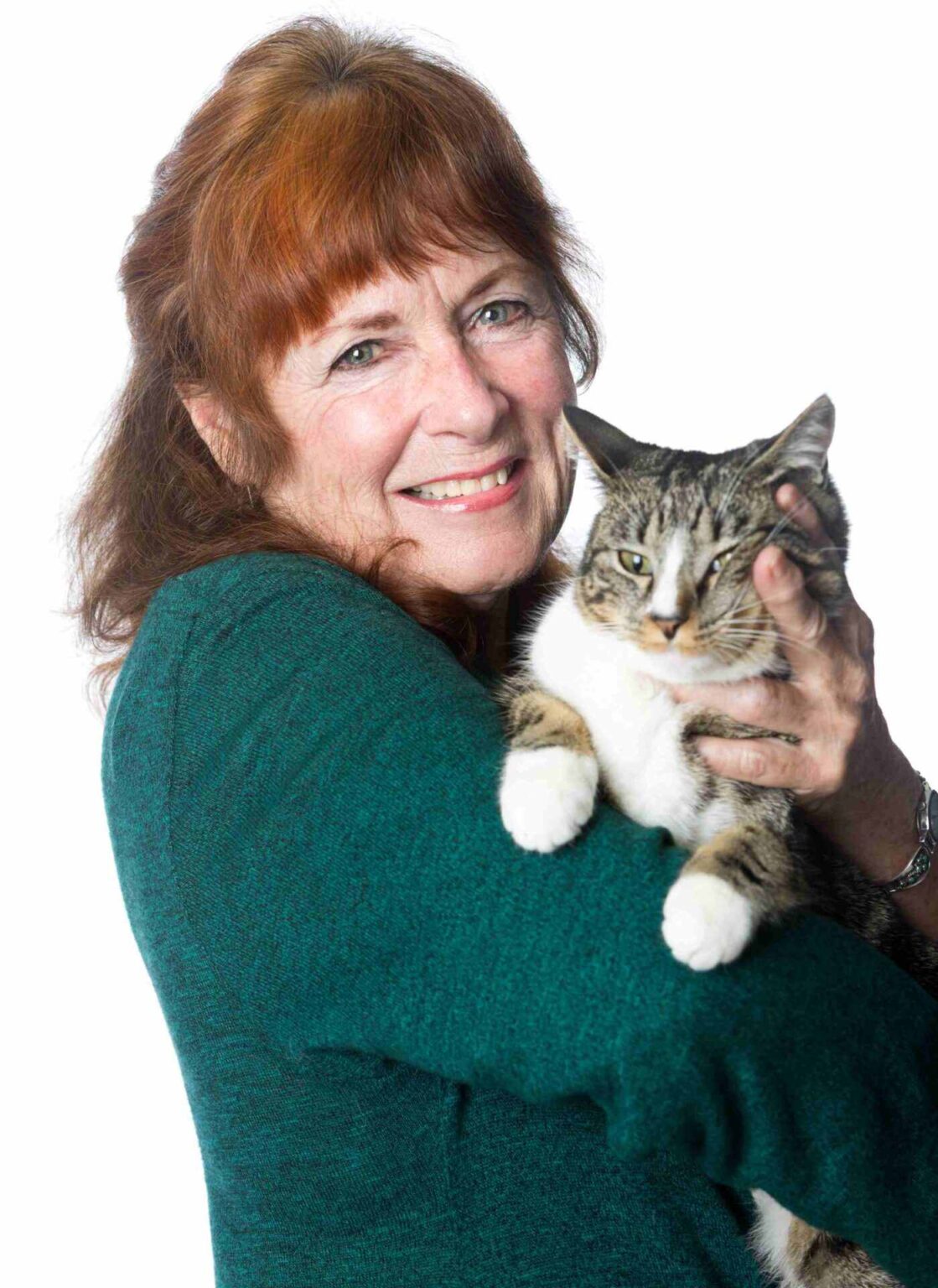 A woman holding a cat in her arms.